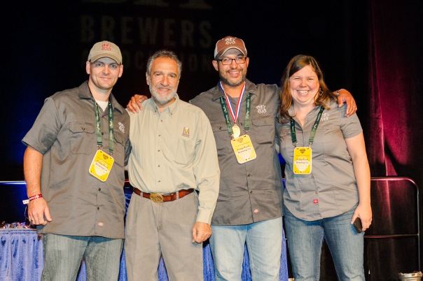 Piney River Brewing received their gold medal at the 2013 Great American Beer Festival awards ceremony held in Denver on Saturday morning.  Shown here, left to right:  Lucas Clem, brewer; Charlie Papazian, president of the Brewer’s Association; Brian Durham, head brewer and co-founder; Joleen Durham, co-founder and original keg washing queen. Not present, Amber Powell, brewer. 